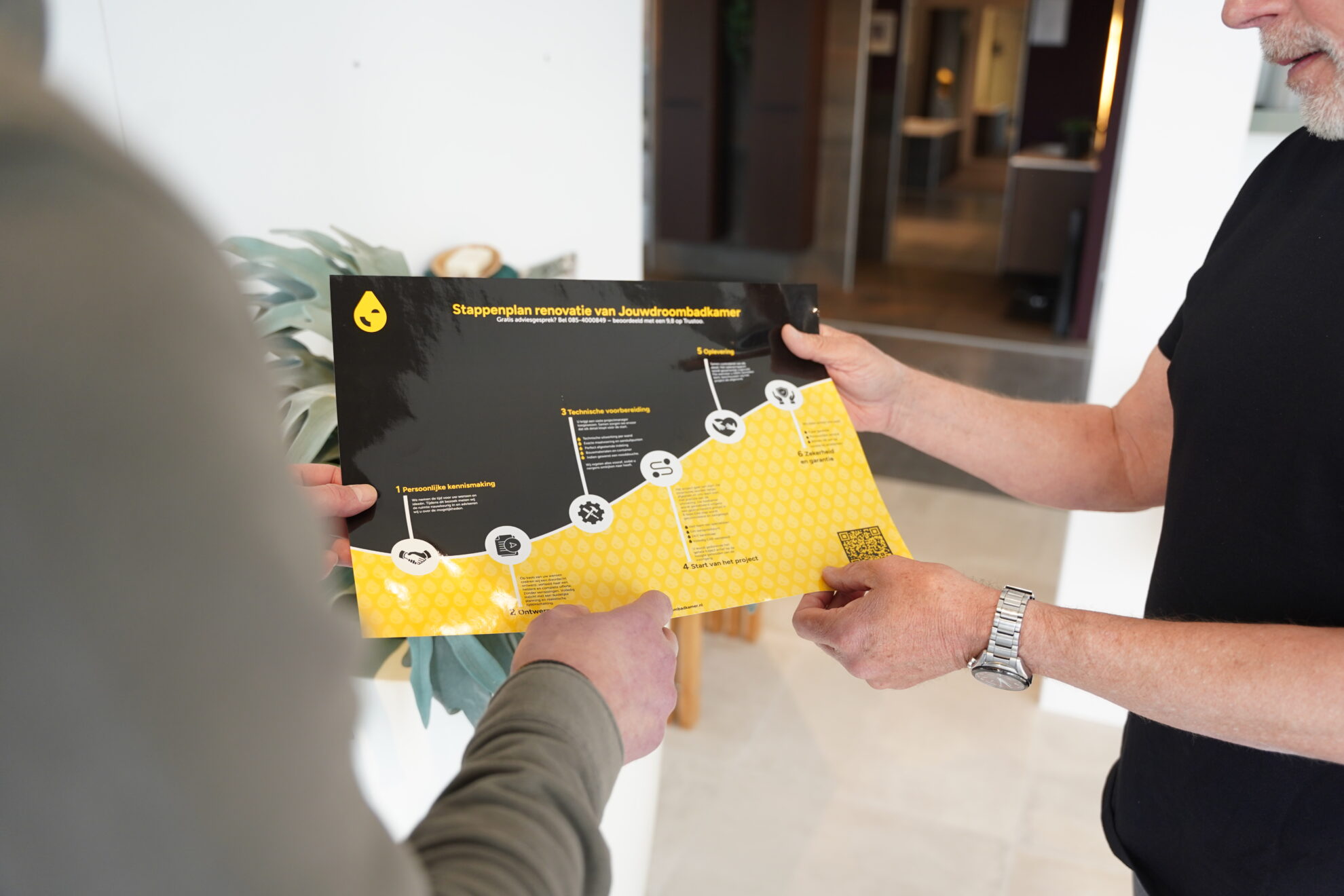 Adviseur bespreekt het renovatieproces van een badkamer aan de hand van een stappenplan.